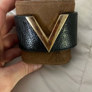 Looks like Valentino cuff black leather bracelet with gold “V”